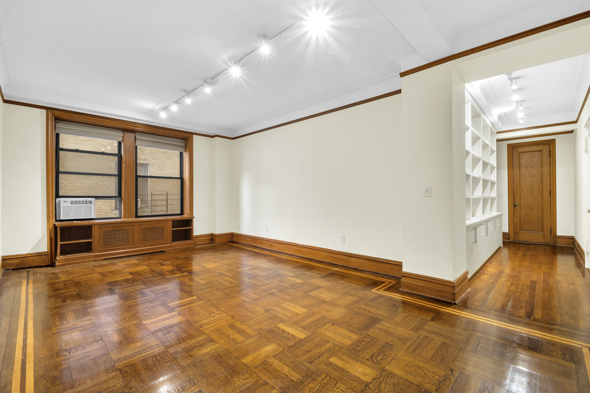 790 Riverside Drive, Unit 5F Manhattan, NY 10032 - Photo 2 of 12 a view of an empty room with a window and wooden floor