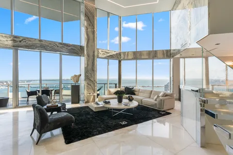 a living room with large windows and furniture
