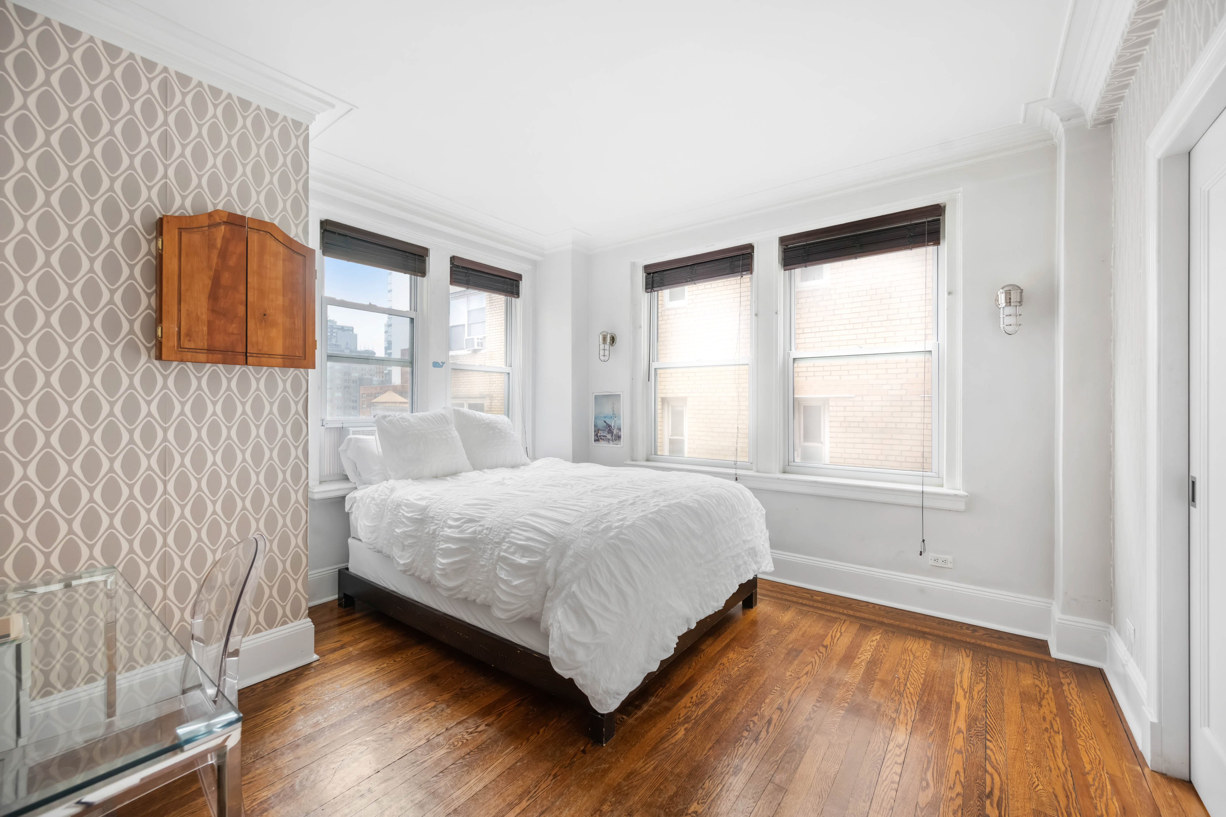 136 East 36th Street, Unit 9/10C Manhattan, NY 10016 - Photo 16 of 27 a bed sitting in a bedroom next to a window