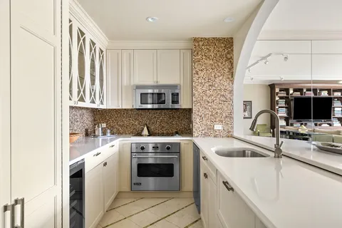 a kitchen with a sink stove and cabinets