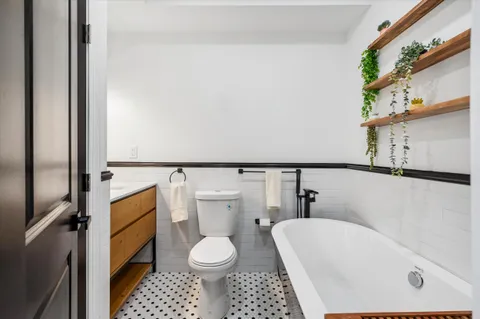 a white toilet sitting next to a bathroom sink