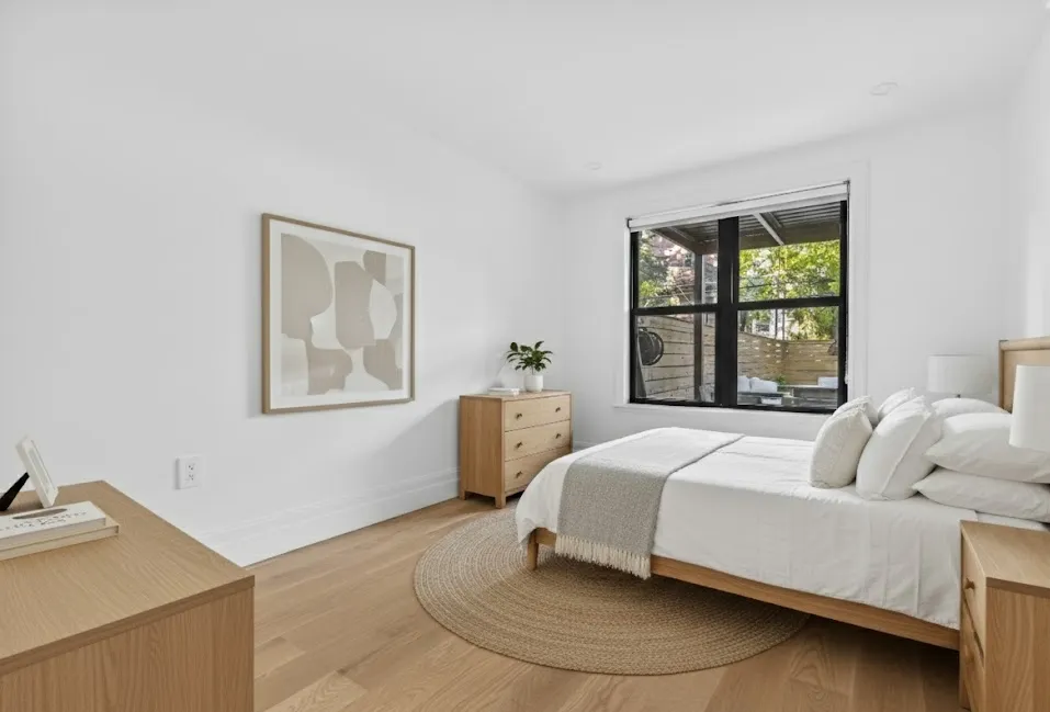 a bedroom with a bed and window