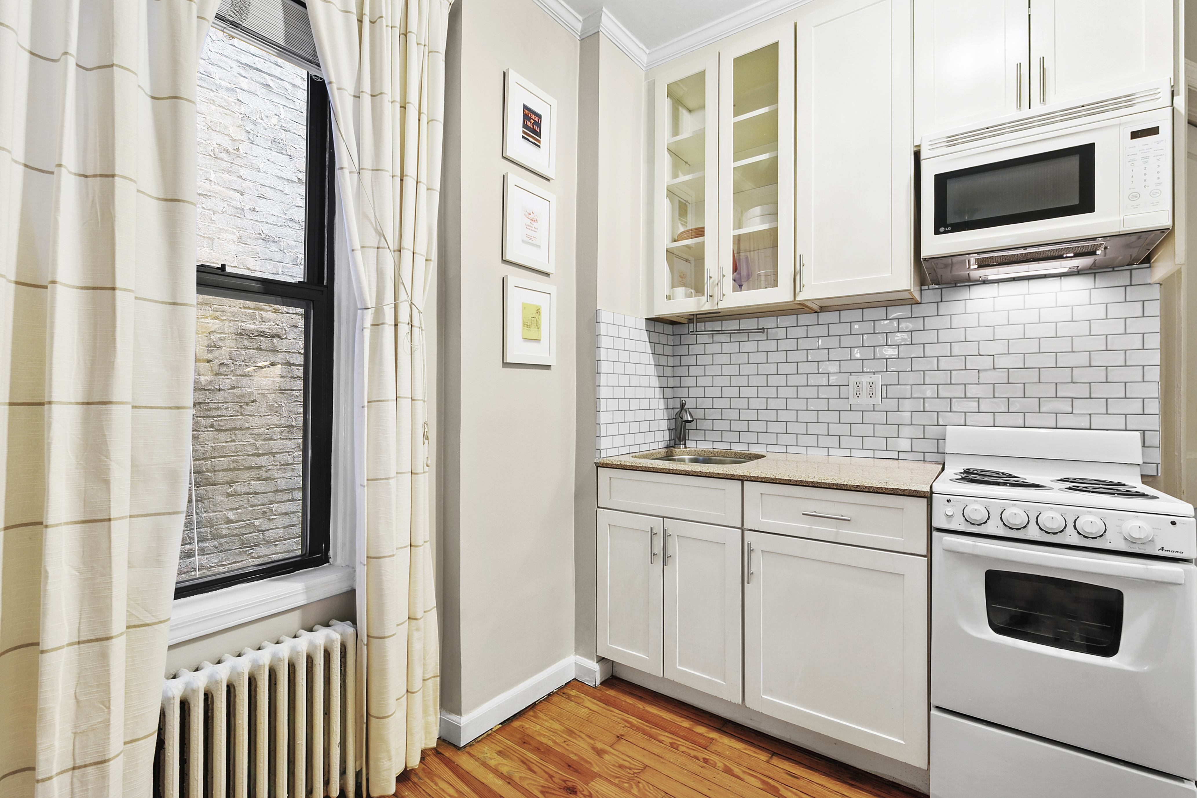 25 Leroy Street, Unit 11 Manhattan, NY 10014 - Photo 3 of 4 a kitchen with a stove and a microwave