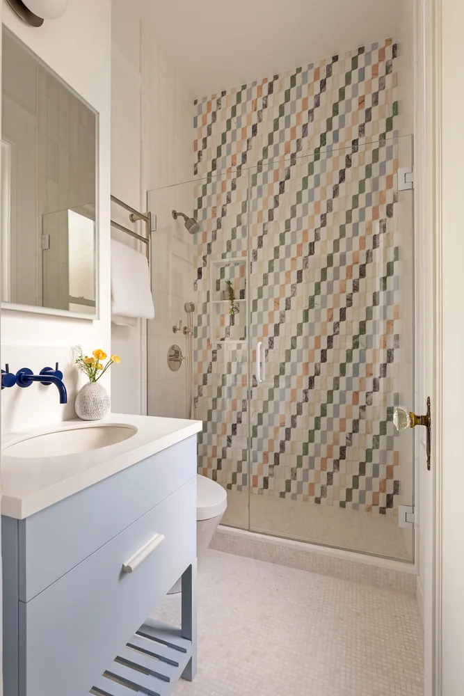 a bathroom with a sink a vanity and a shower