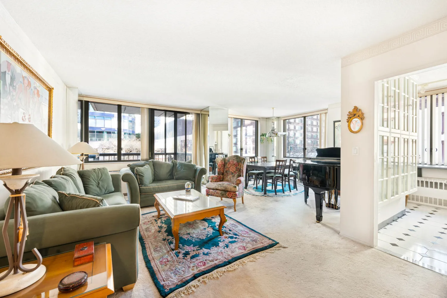 a living room with furniture a rug and a window