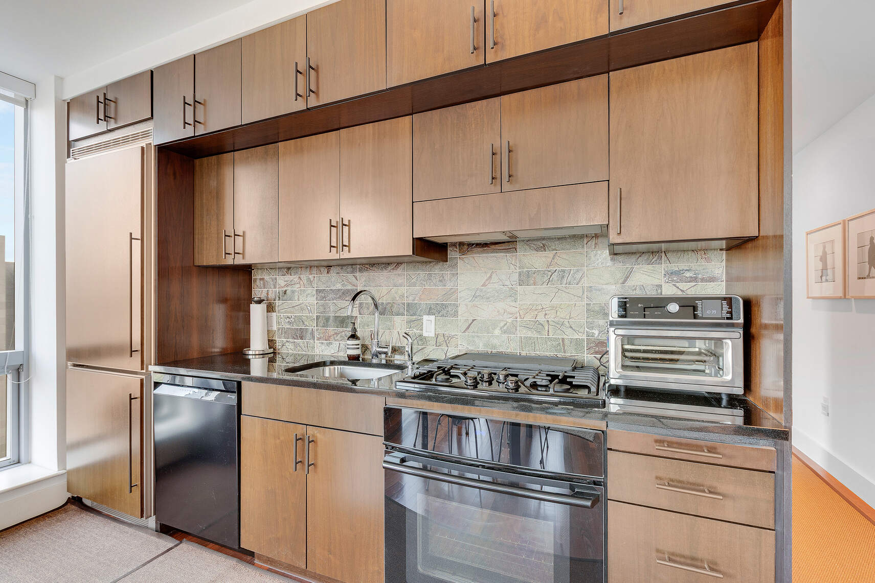 150 Myrtle Avenue, Unit 2503 Brooklyn, NY 11201 - Photo 5 of 28 a kitchen with stainless steel appliances granite countertop a refrigerator stove and white cabinets