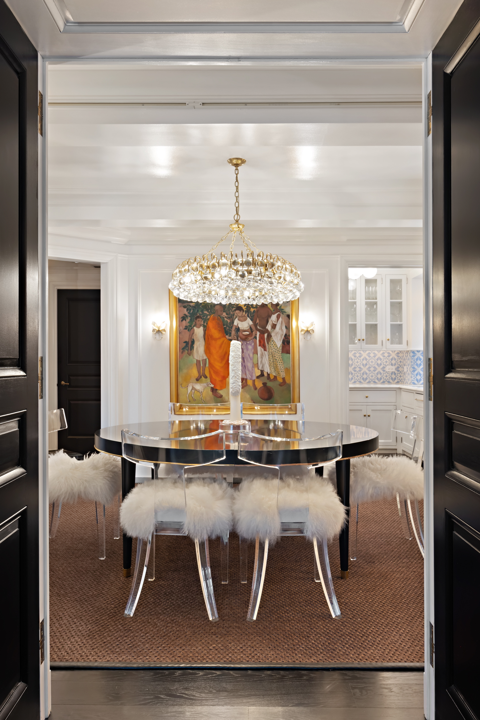 170 East 78th Street, Unit 8E Manhattan, NY 10075 - Photo 6 of 16 a dining room with wooden floor a chandelier a glass table and chairs