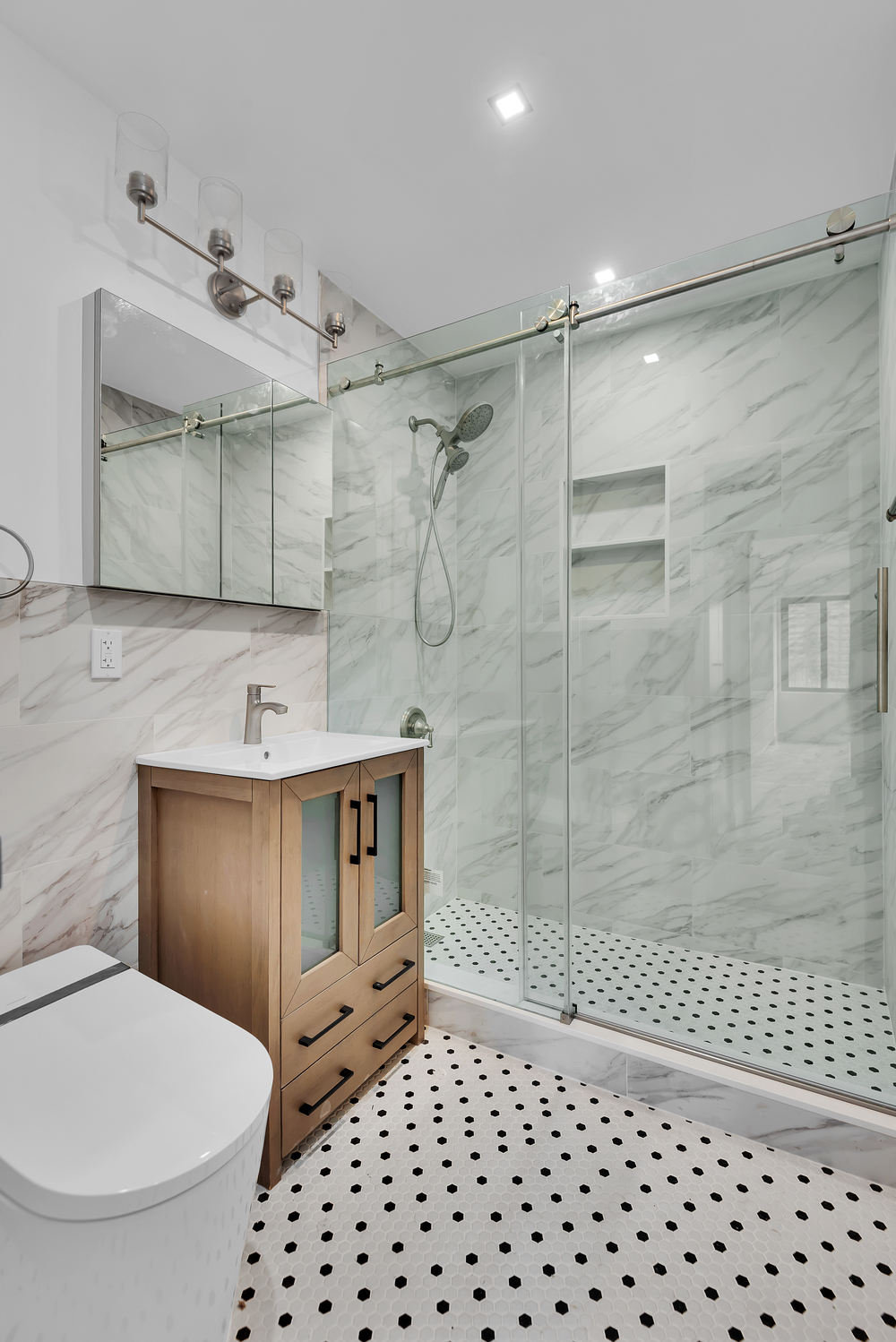 20 West 64th Street, Unit 20K Manhattan, NY 10023 - Photo 8 of 17 a bathroom with a sink toilet and shower