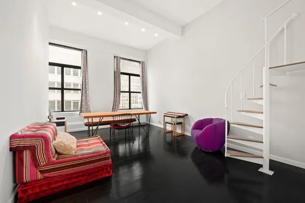 a bedroom with furniture and a window