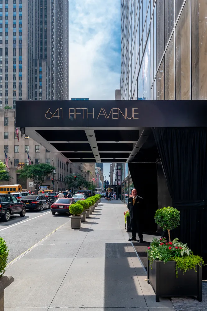 a living room with furniture a fireplace and a large window