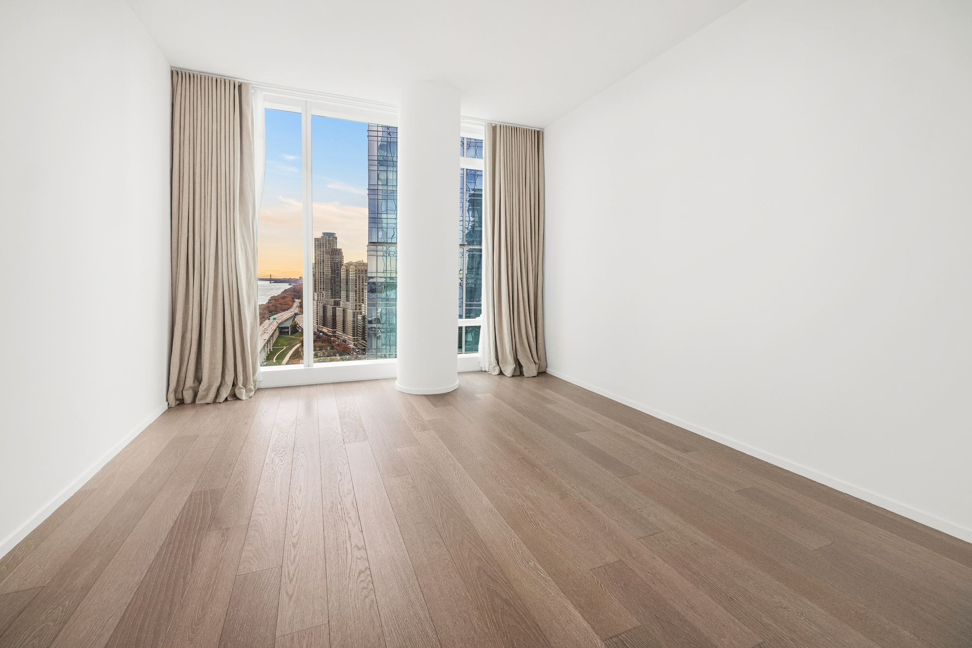 30 Riverside Boulevard, Unit 29B Manhattan, NY 10069 - Photo 9 of 20 an empty room with wooden floor and windows