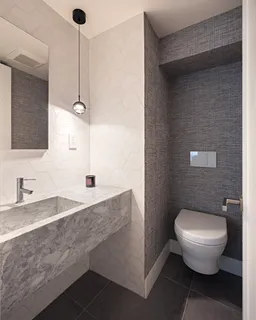 a bathroom with a granite countertop sink a toilet and a mirror