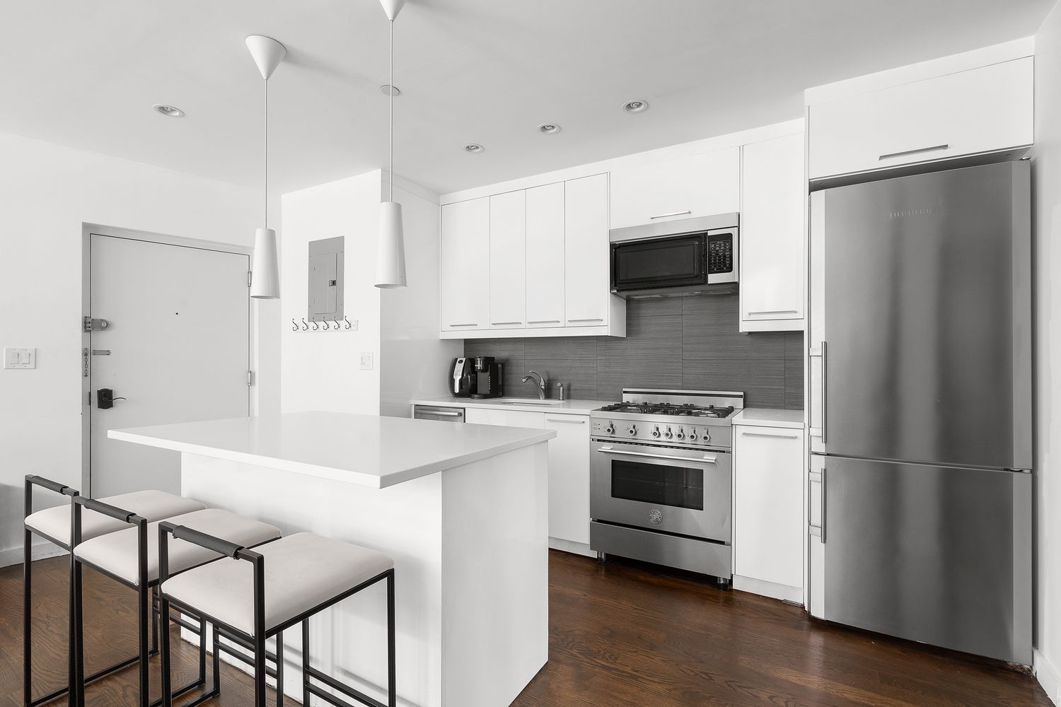 51 East 128th Street, Unit 1C Manhattan, NY 10035 - Photo 2 of 9 a kitchen with a stove a refrigerator and a microwave