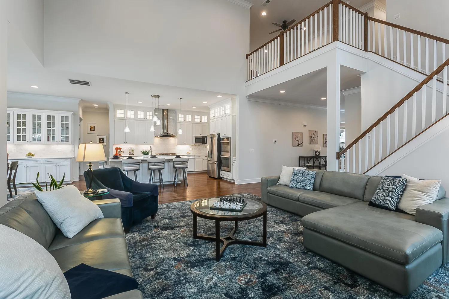 a living room with furniture kitchen view and a table