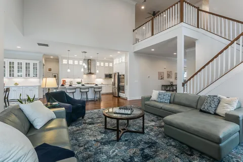 a living room with furniture kitchen view and a table