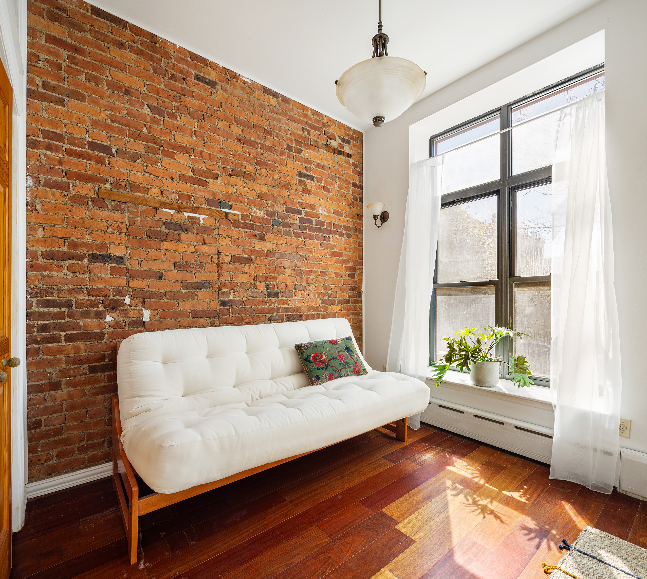 37 Quincy Street Brooklyn, NY 11238 - Photo 5 of 24 a bedroom with a bed and window