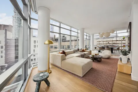 a living room with fireplace furniture and a large window