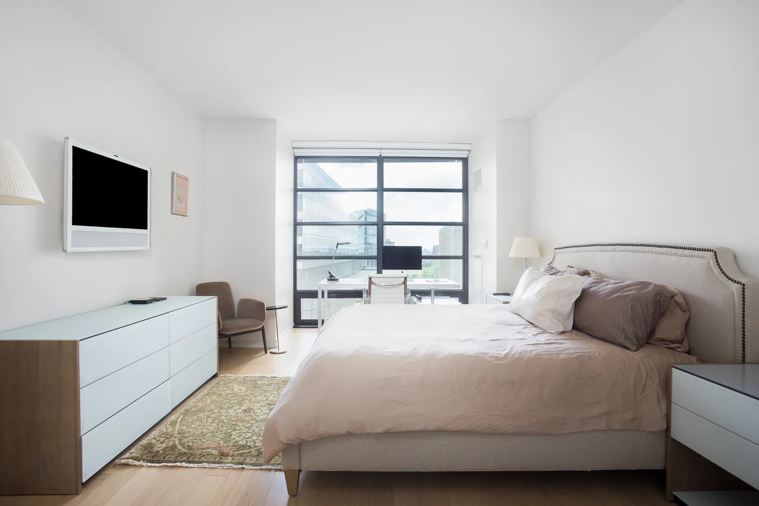 a bedroom with a bed and a flat screen tv
