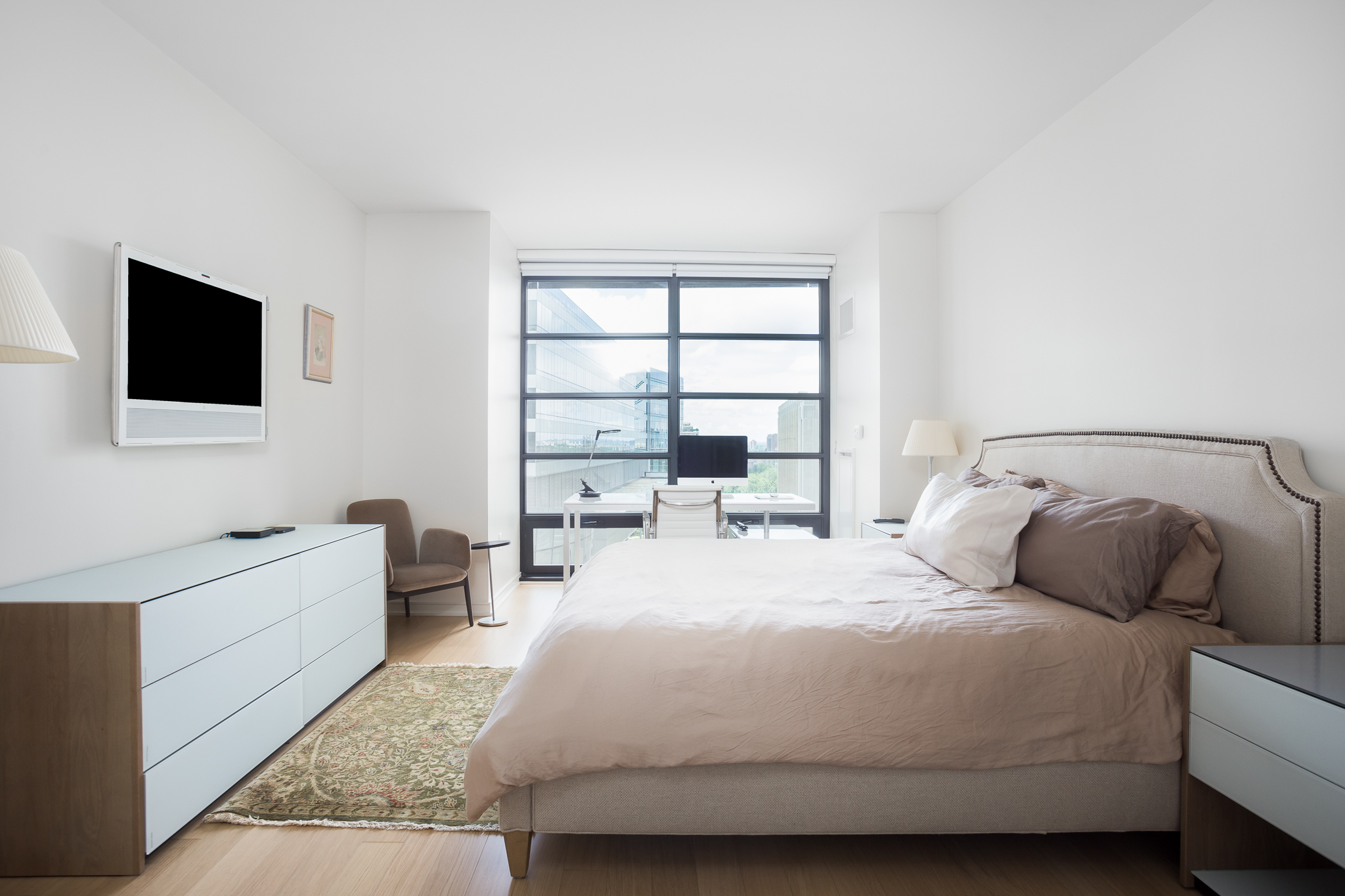 580 Washington Street, Unit 11B Boston, MA 02111 - Photo 4 of 9 a bedroom with a bed and a flat screen tv