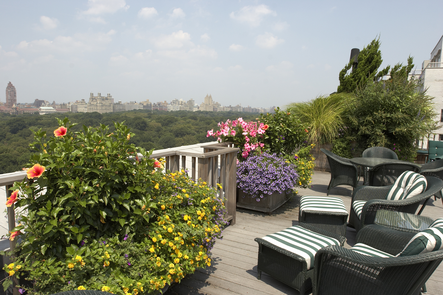907 5th Avenue, Unit 4F Manhattan, NY 10021 - Photo 9 of 13 a view of a patio with couches plants and large trees