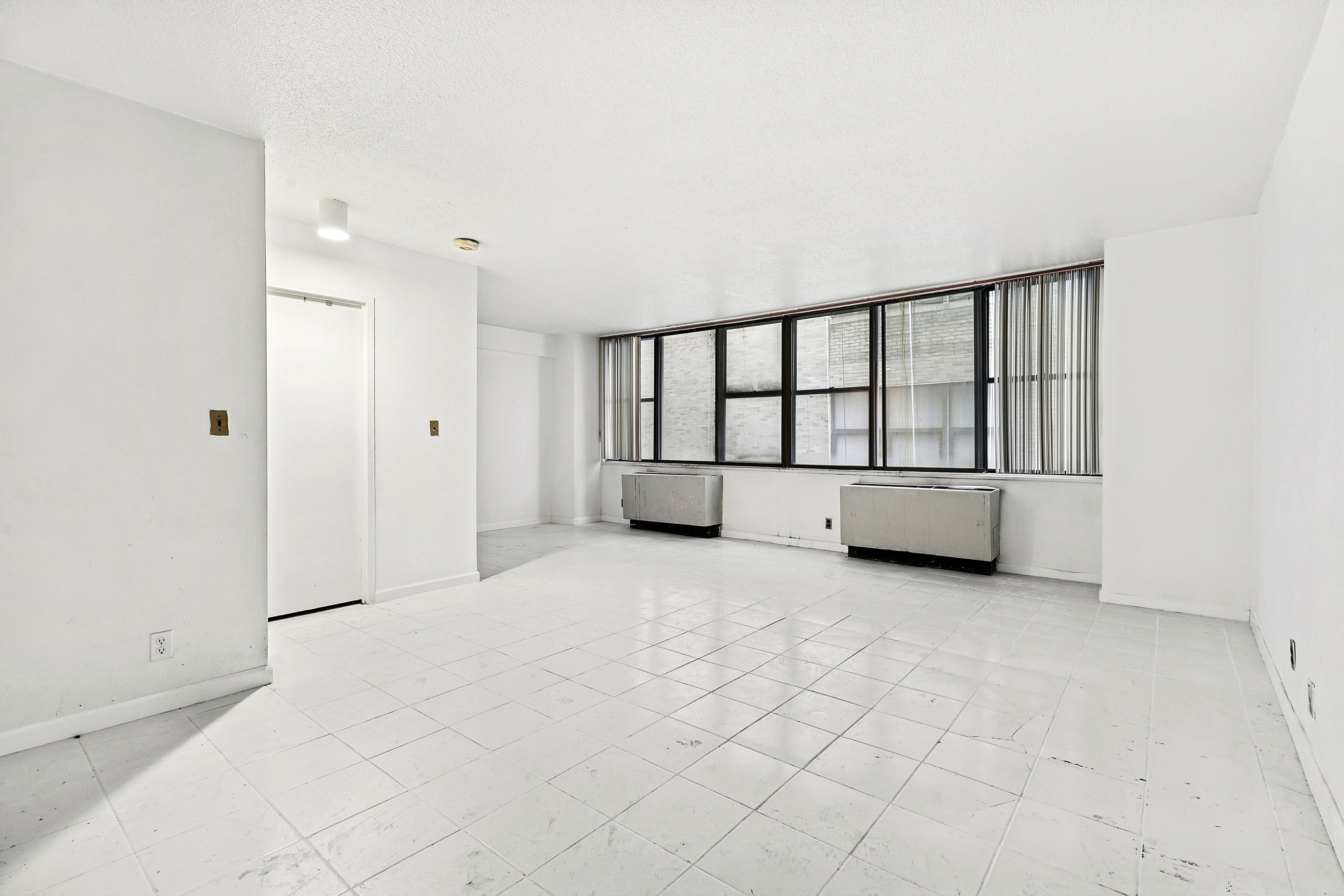 301 East 45th Street, Unit 8A Manhattan, NY 10017 - Photo 1 of 11 a view of an empty room with a window