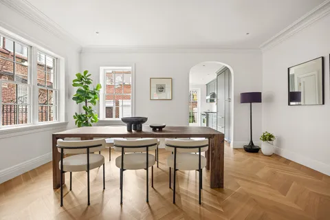 a view of a dining room with furniture and window