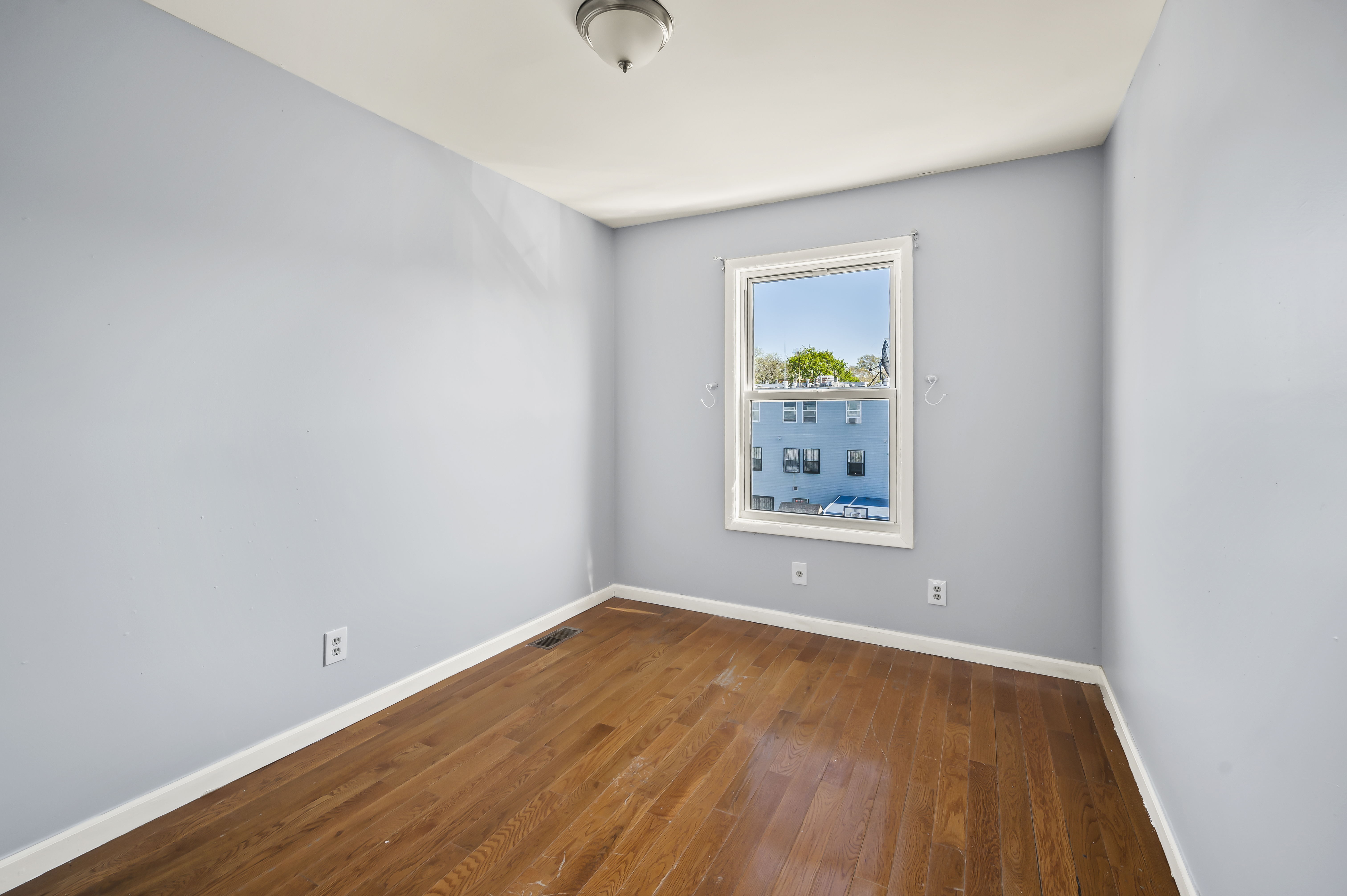 930 Jefferson Avenue, Unit 2 Brooklyn, NY 11221 - Photo 8 of 12 a view of empty room with wooden floor and fan