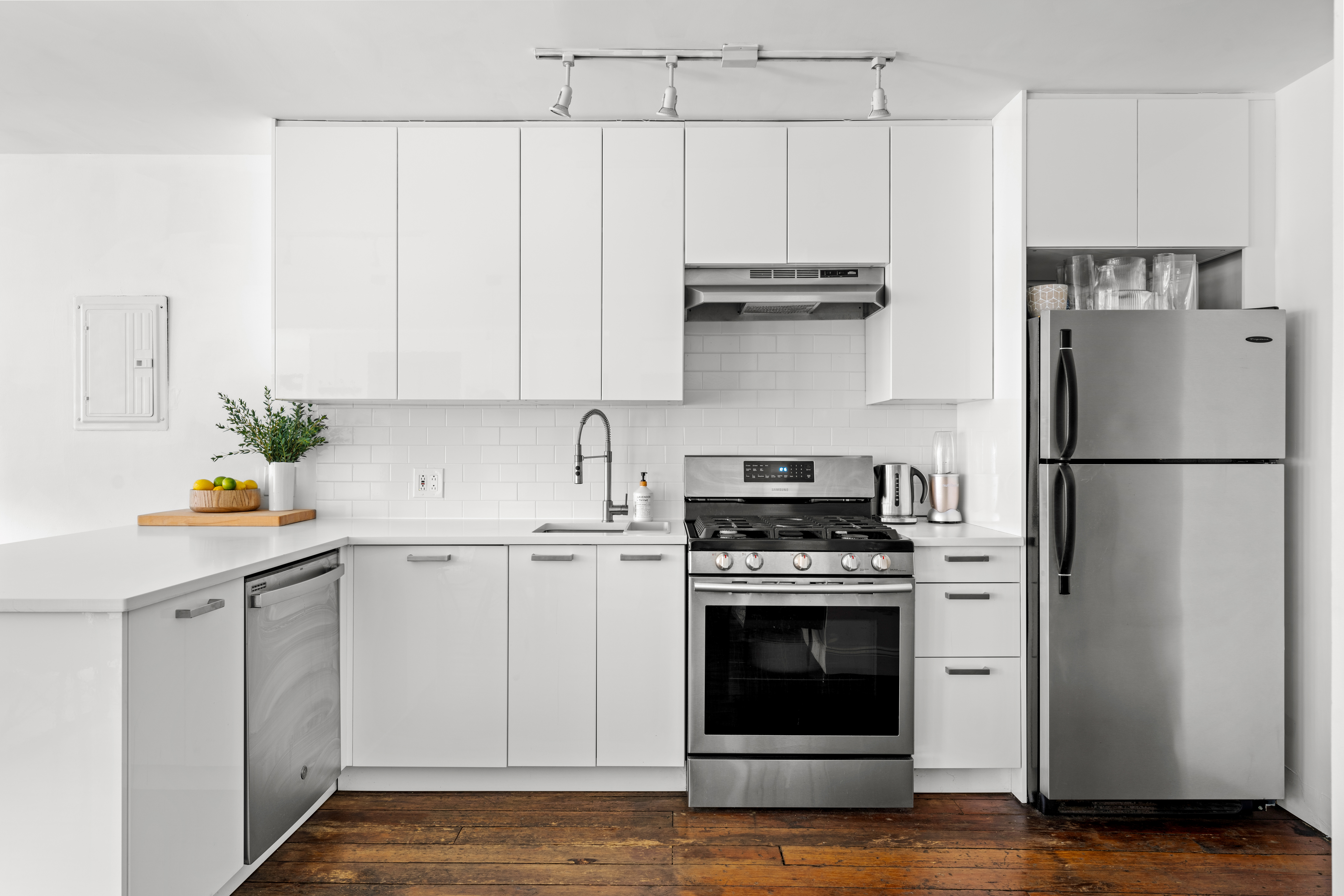 24 Harrison Street, Unit 3 Manhattan, NY 10013 - Photo 3 of 11 a kitchen with appliances cabinets and a counter top