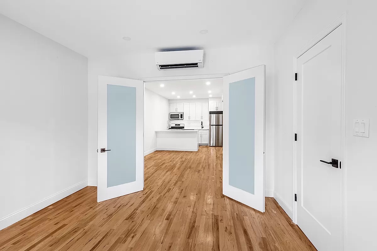 1097 Park Place, Unit 1 Brooklyn, NY 11213 - Photo 2 of 9 a view of a hallway with wooden floor and a bathroom