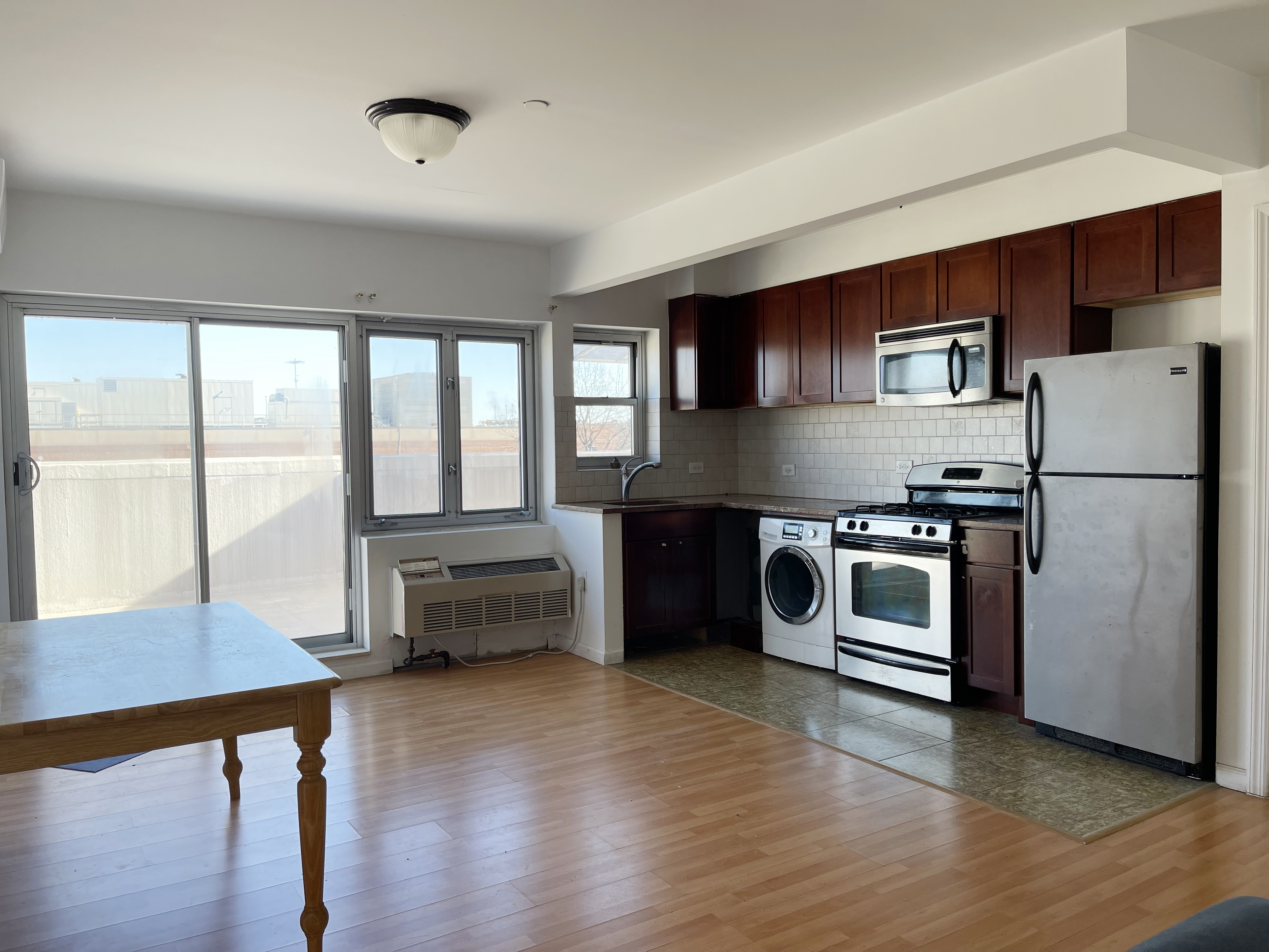 71-33 162nd Street, Unit 5A Queens, NY 11365 - Photo 2 of 5 a kitchen with stainless steel appliances granite countertop a refrigerator and a stove