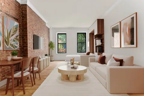 a living room with furniture and a large mirror next to a window