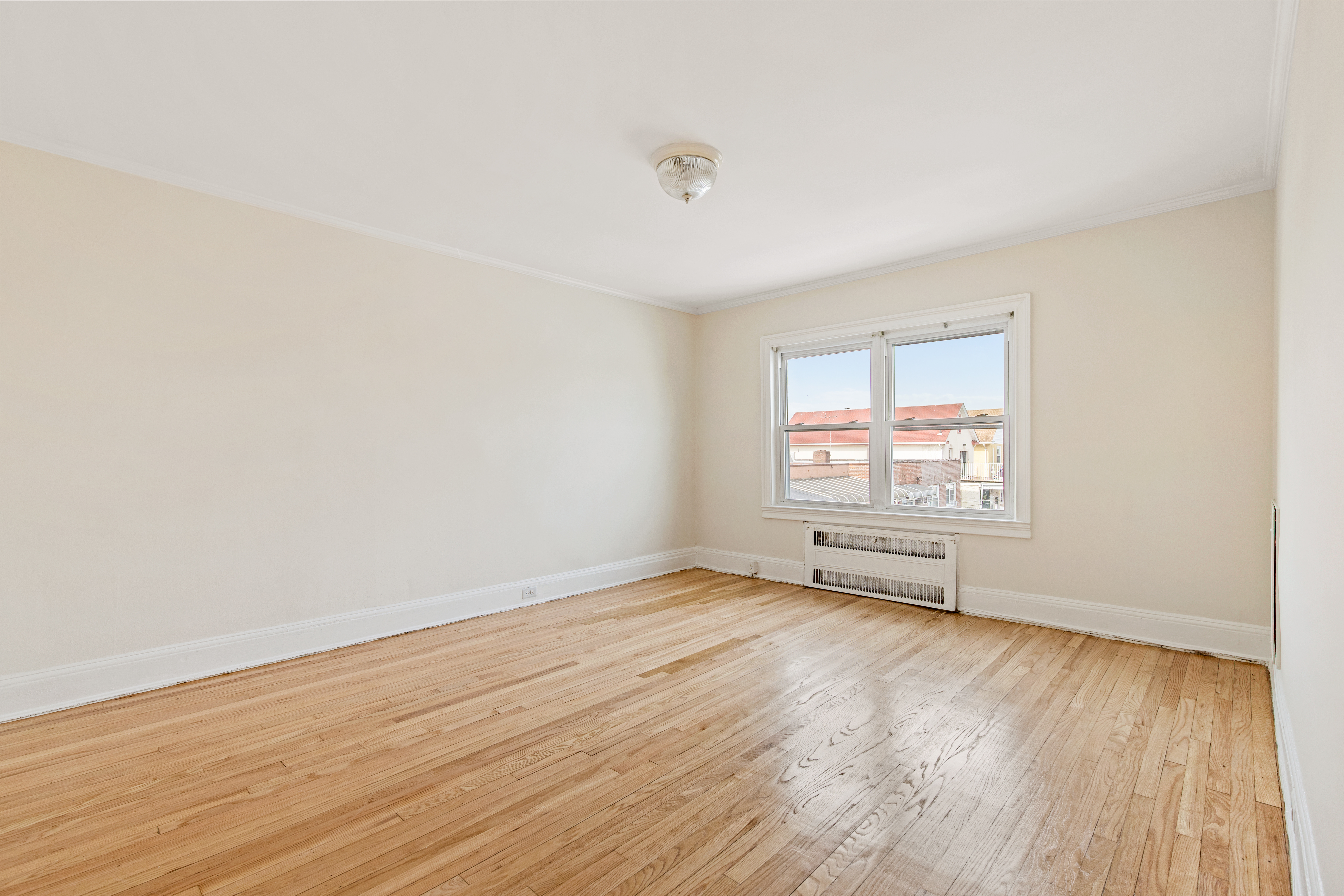 32 Tudor Terrace Brooklyn, NY 11224 - Photo 7 of 15 an empty room with wooden floor and windows