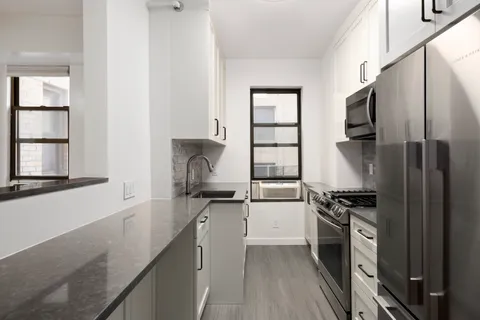 a kitchen with a sink stove and refrigerator