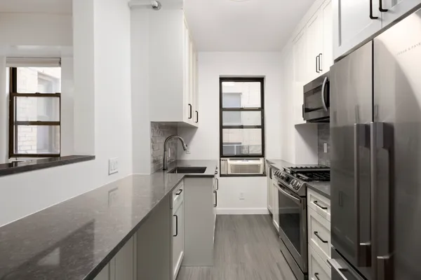 a kitchen with a sink stove and refrigerator