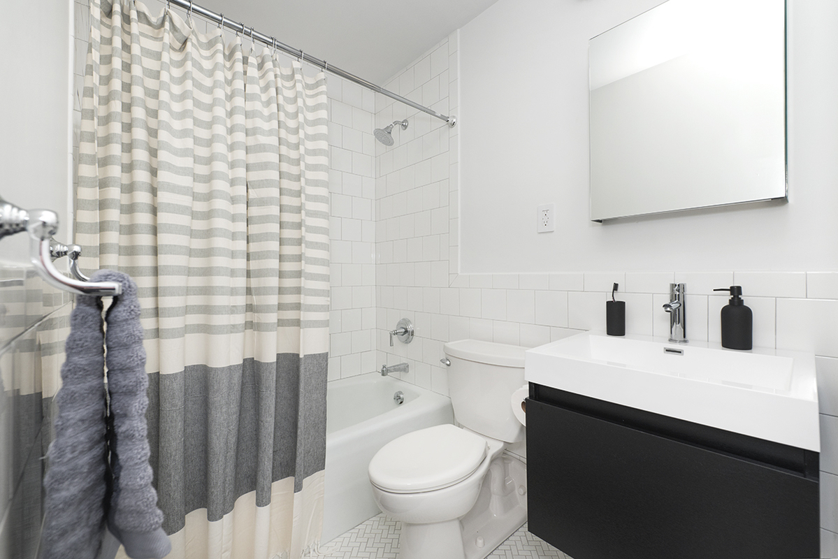 275 South Street, Unit 7PP Manhattan, NY 10002 - Photo 4 of 19 a bathroom with a sink toilet and shower
