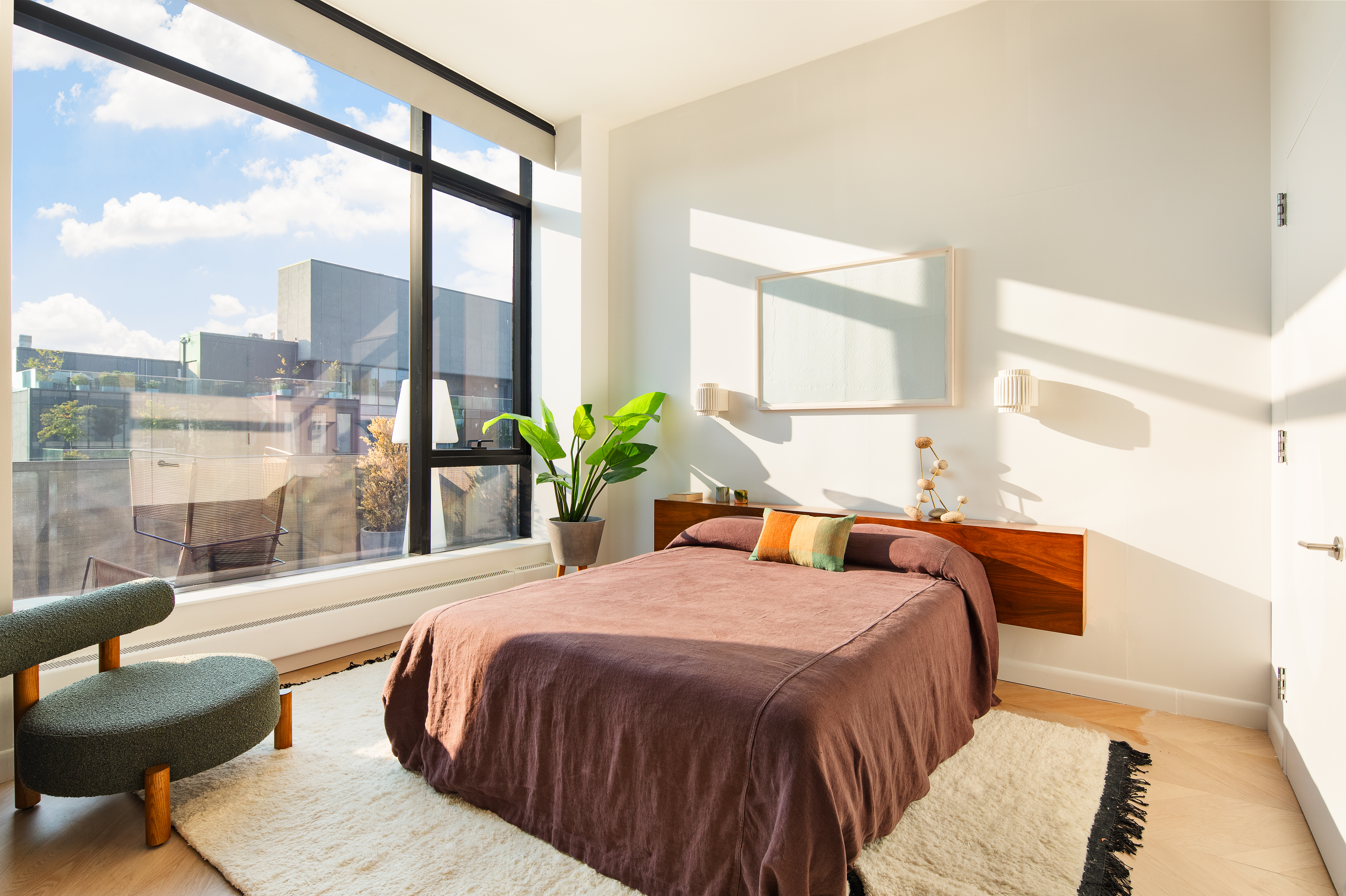 255 Hudson Street, Unit PHB Manhattan, NY 10013 - Photo 7 of 10 a bedroom with a large bed and a potted plant