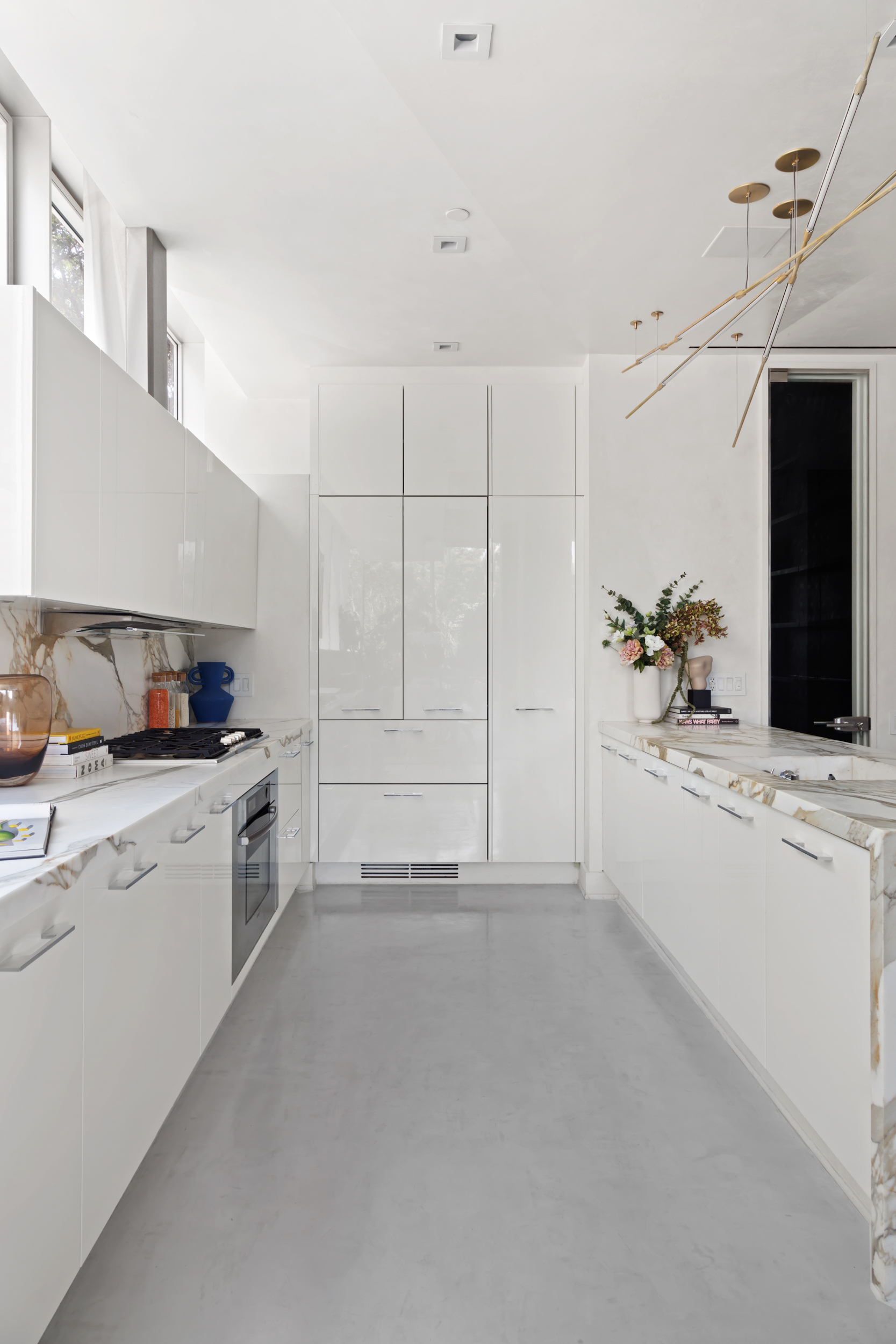 471 Washington Street, Unit 1B Manhattan, NY 10013 - Photo 10 of 17 a kitchen with cabinets and white appliances