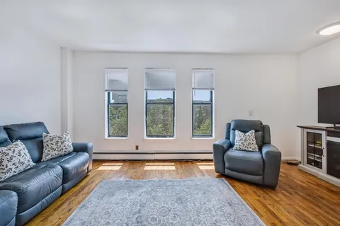 a living room with furniture and a rug