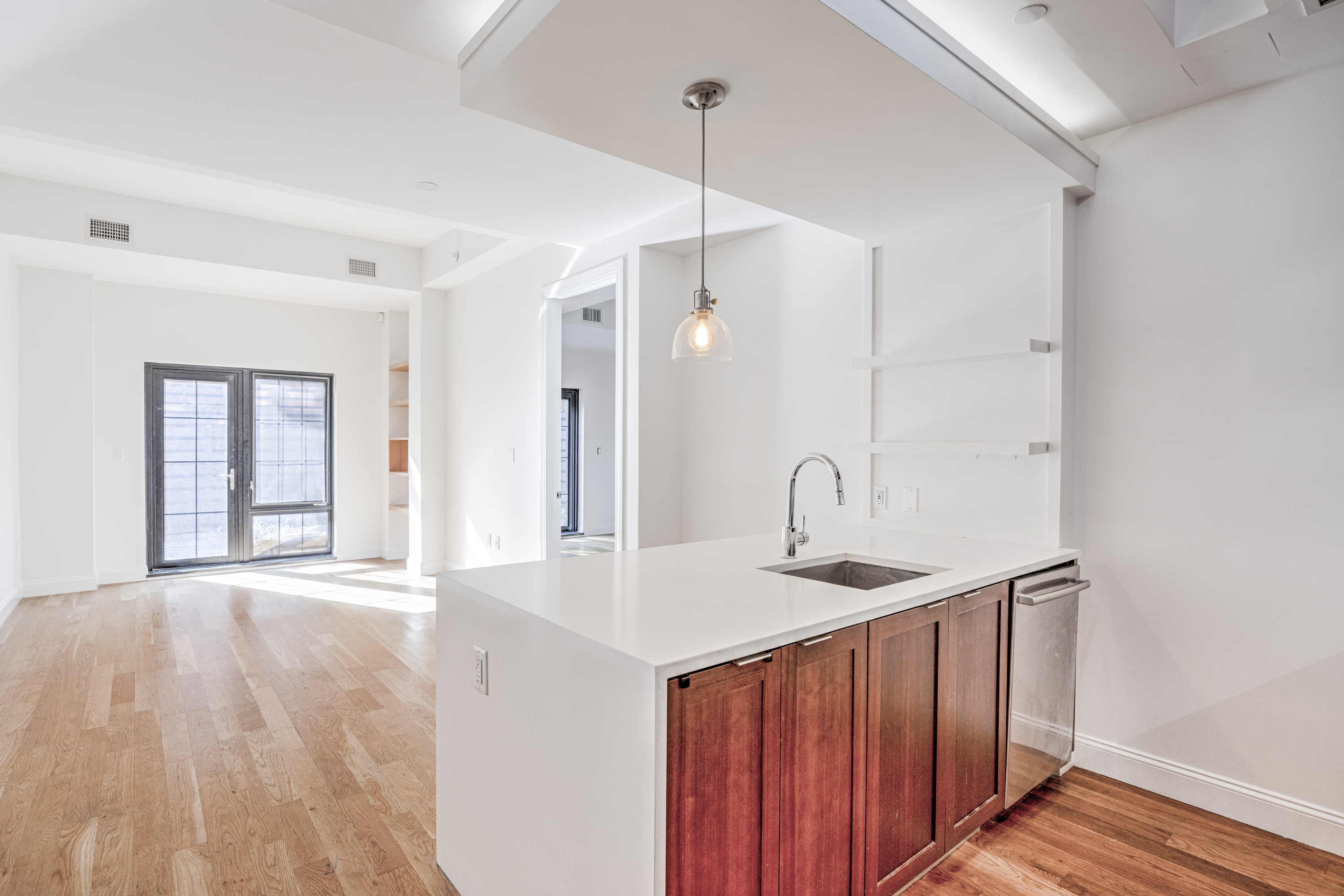 42 Maspeth Avenue, Unit 1D Brooklyn, NY 11211 - Photo 13 of 28 a hallway with a sink a window and wooden floor