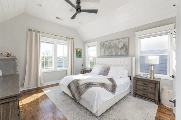 a bedroom with a bed and a painting on the wall