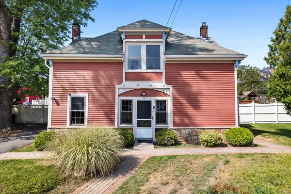 a front view of a house with garden