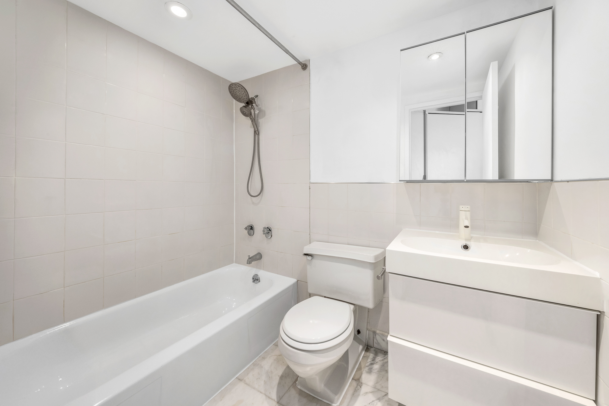 77 Bleecker Street, Unit 617 Manhattan, NY 10012 - Photo 12 of 13 a bathroom with a sink a toilet and a bathtub