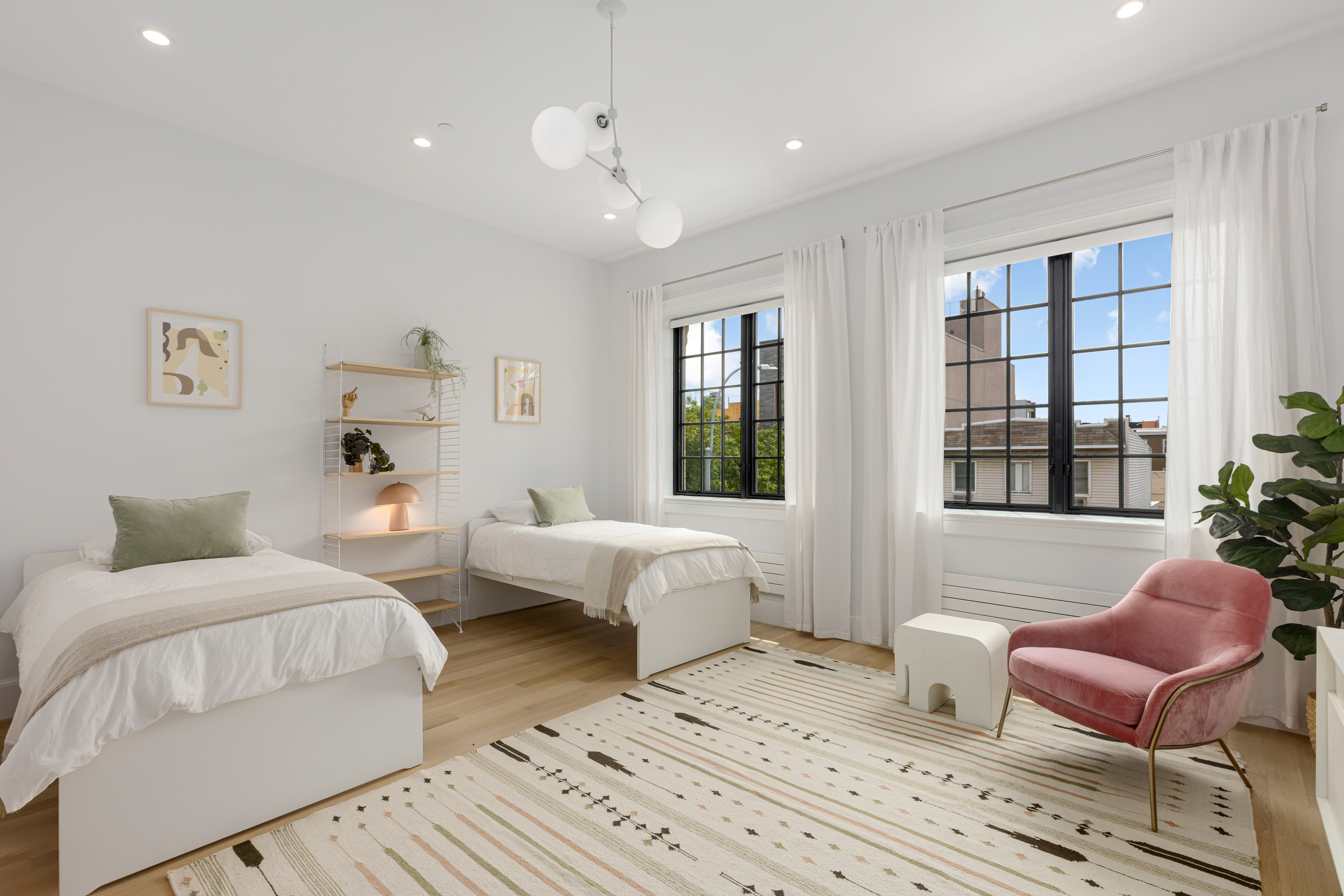 179 Devoe Street Brooklyn, NY 11211 - Photo 10 of 20 a spacious bedroom with two beds and a large window