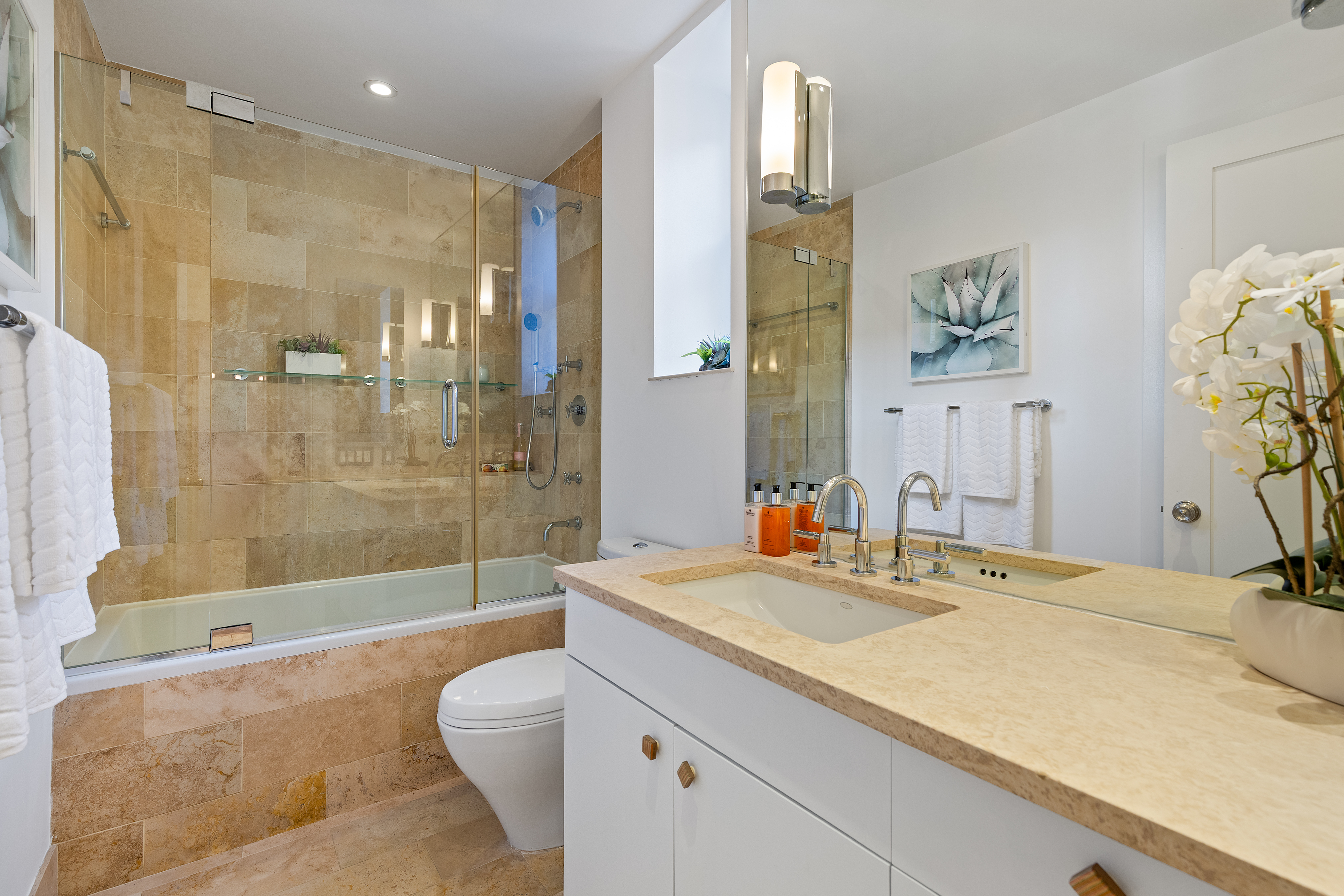 59 West 71st Street, Unit 9C Manhattan, NY 10023 - Photo 7 of 11 a bathroom with a granite countertop sink a toilet and shower