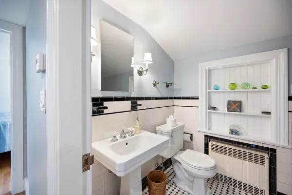 a bathroom with a sink a toilet and a mirror