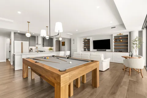 a kitchen with stainless steel appliances granite countertop a stove and a wooden floor