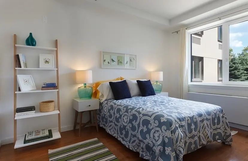 22 Caton Place, Unit 4H Brooklyn, NY 11218 - Photo 5 of 20 a bed sitting in a bedroom next to a window