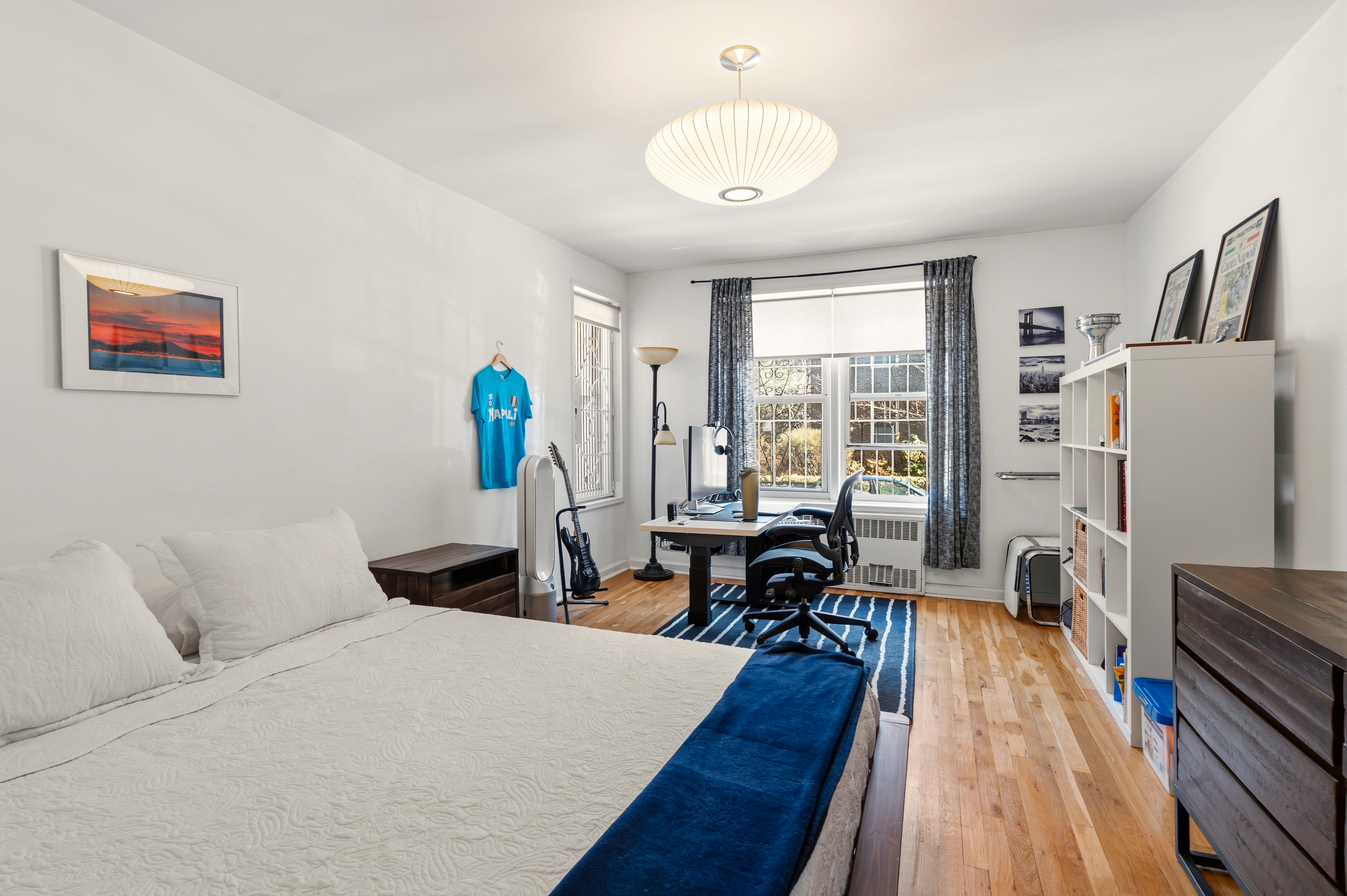 79-10 34th Avenue, Unit 2J Queens, NY 11372 - Photo 6 of 9 a living room with furniture and a table
