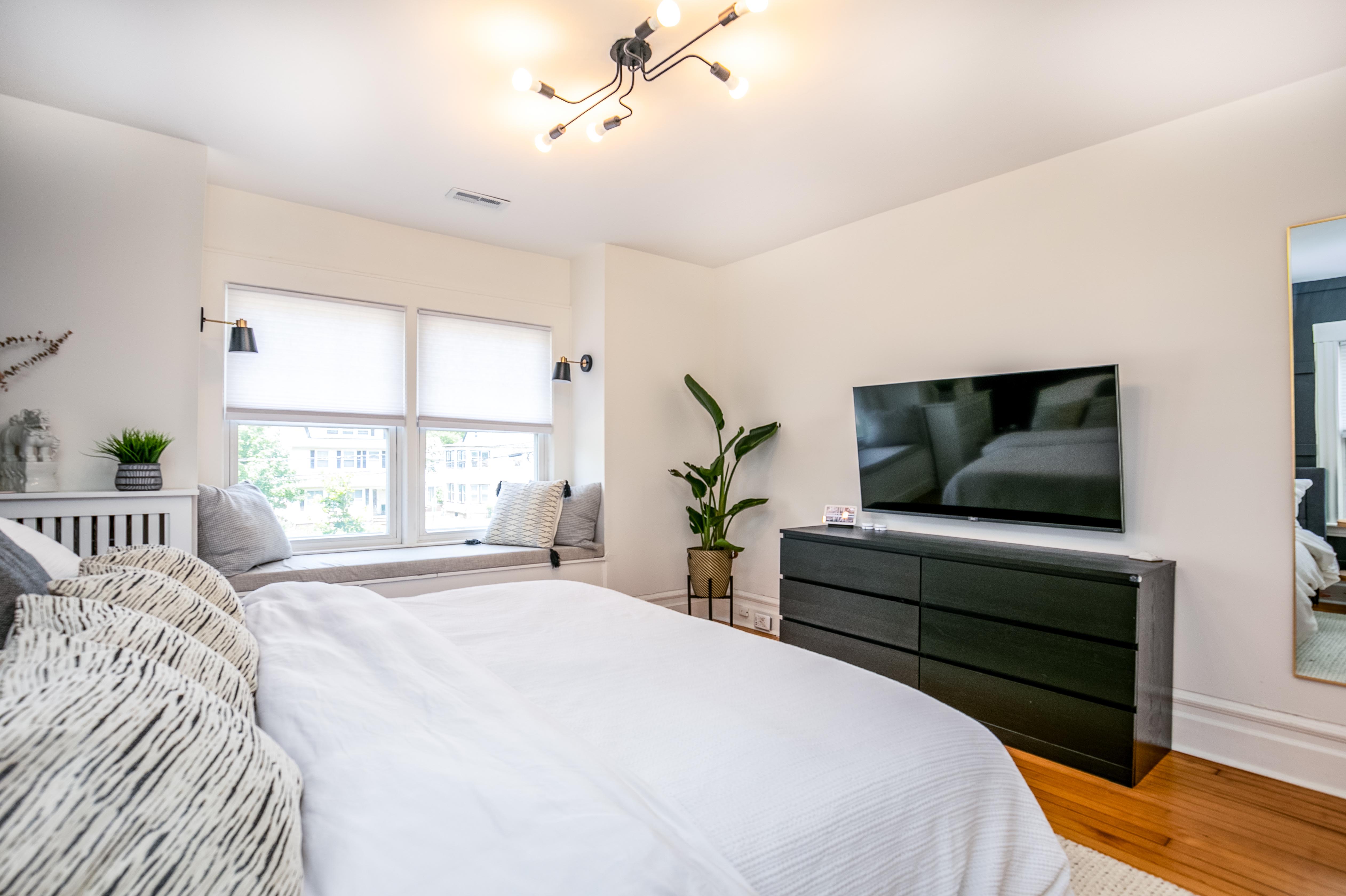 163 Ridge Road Rutherford, NJ 07070 - Photo 33 of 59 a bedroom with a bed and a flat screen tv