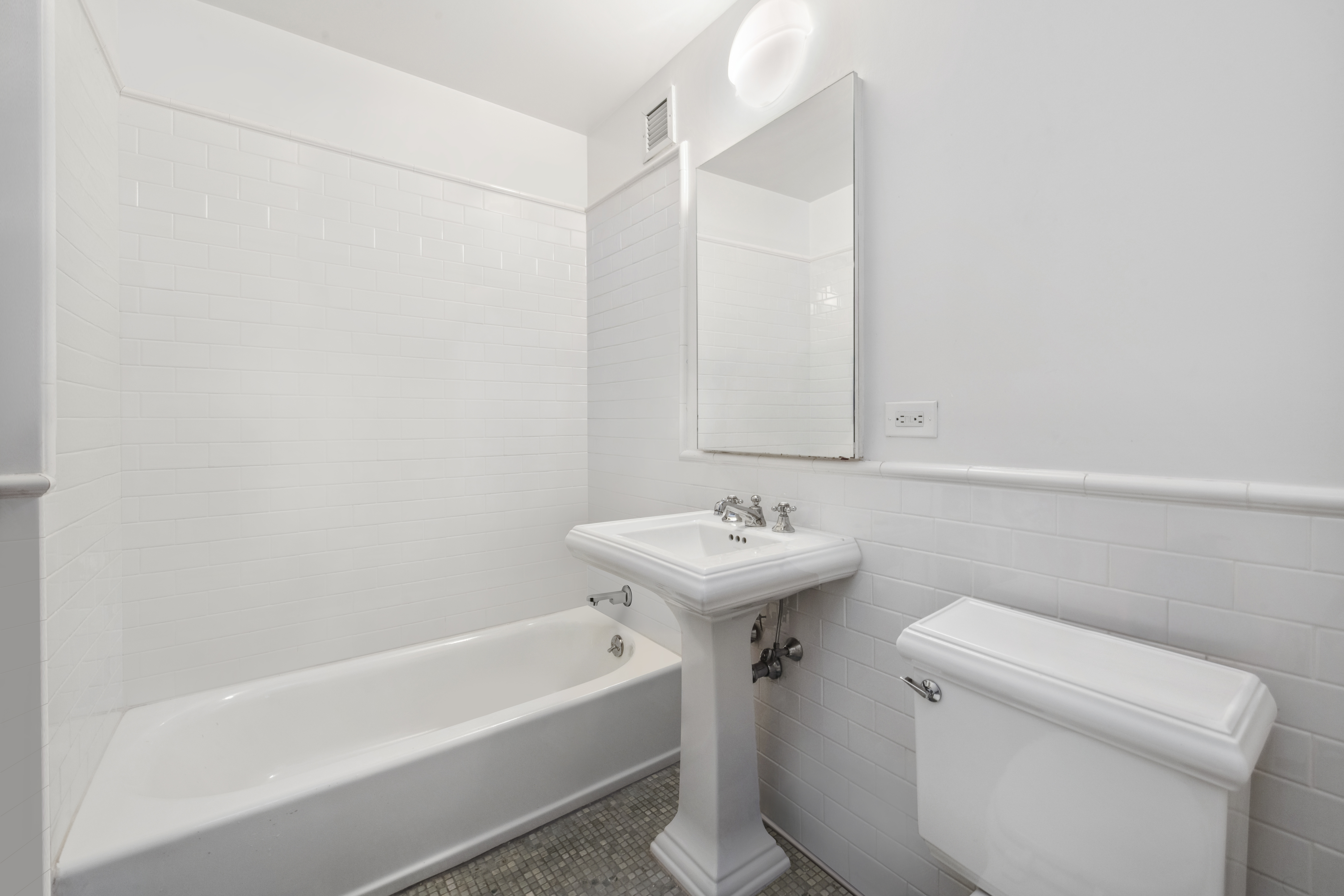 151 West 17th Street, Unit 5A Manhattan, NY 10011 - Photo 8 of 11 a bathroom with a sink a toilet and bathtub